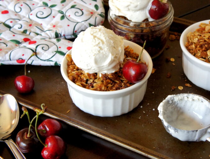 This Sweet Cherry Crisp uses fresh cherries and a crumbly oat topping to make a delicious summer dessert. Top with ice cream!