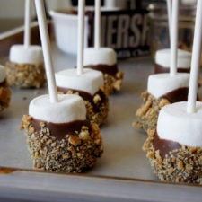 A close up of a pan of S'more dipped marshmallow pops