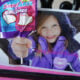 A close up of a Valentine's Day card; picture of little girl holding hand out with a lollipop attached to the picture.