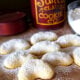 A close up of powdered Almond Crescent Cookies