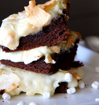 A close up of a couple Gooey Hot Chocolate Cake Bars stacked on a plate