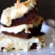 A close up of a couple Gooey Hot Chocolate Cake Bars stacked on a plate