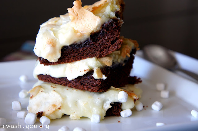 A close up of a couple Gooey Hot Chocolate Cake Bars stacked on a plate