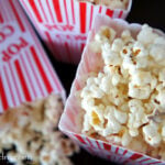 A close up of Cinnamon and White Chocolate Popcorn displayed in a popcorn container