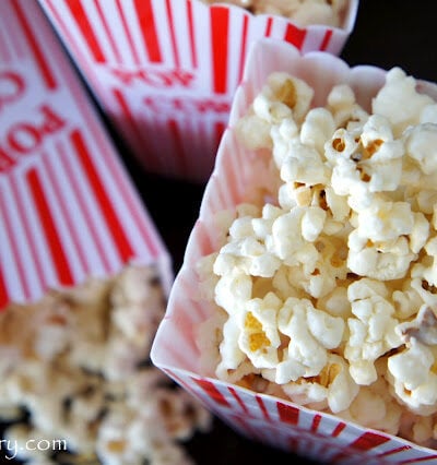A close up of Cinnamon and White Chocolate Popcorn displayed in a popcorn container