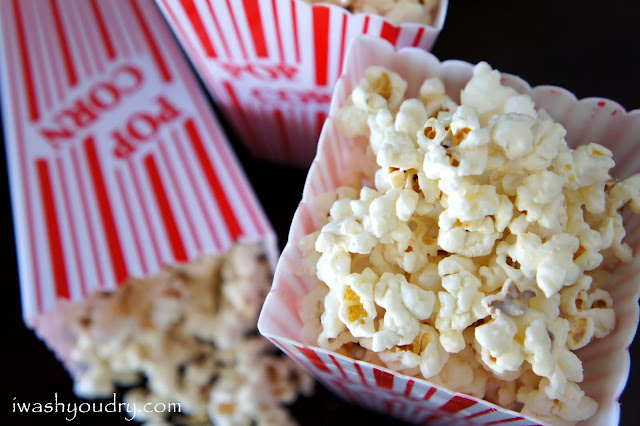 A close up of Cinnamon and White Chocolate Popcorn displayed in a popcorn container