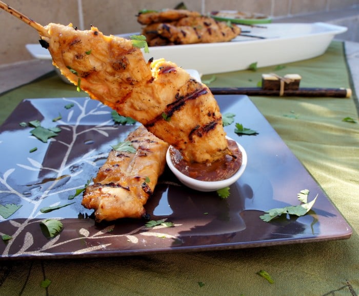 Thai Chicken Satay dipped in a dipping sauce