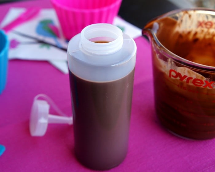 A squeeze bottle filled with chocolate sauce