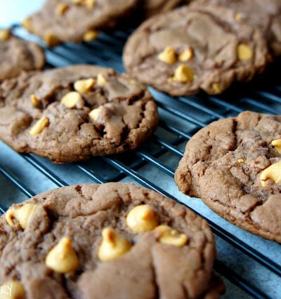 Chocolate cookies with peanut butter chips on a cooling rack