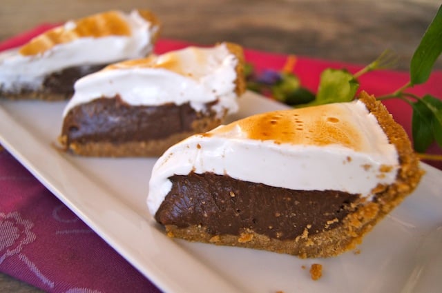 Three slices of Peanut Butter S’mores Meringue Pie displayed on a plate