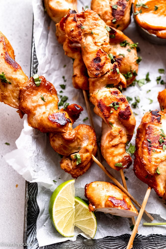 skewered chicken with limes and cilantro