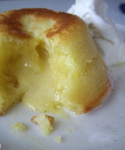 A close up of a a White chocolate Lemon Lava Cake broken open to expose the oozing center.