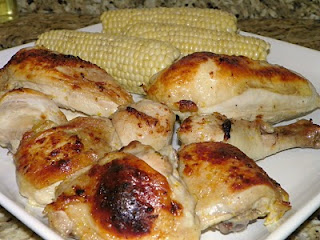 Triple Citrus Chicken on a plate with cobs of corn