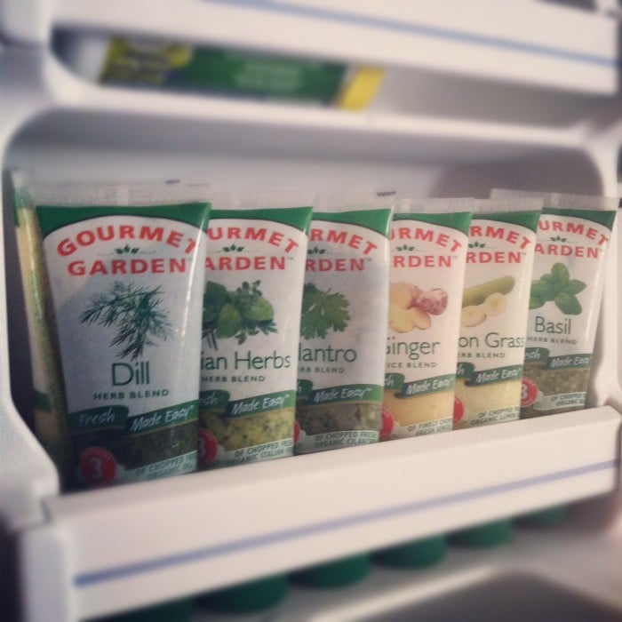 A freezer door with Gourmet Garden tubes of a variety of different herbs