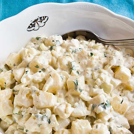 A close up of a bowl of potato salad