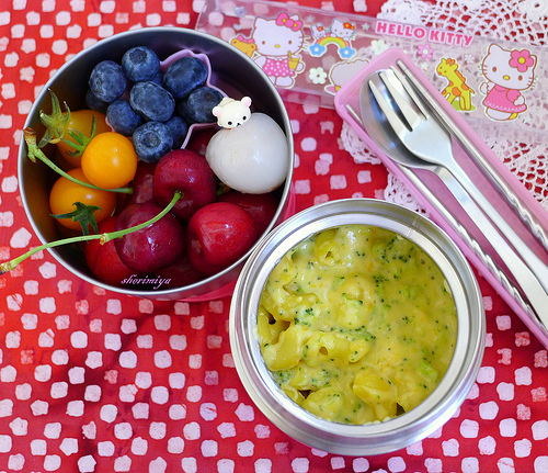 A bowl of soup next to a bowl of fruit