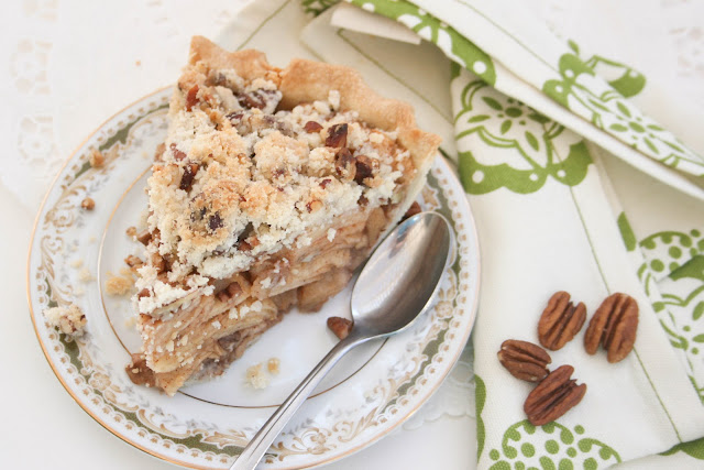 A slice of apple pecan pie on a plate