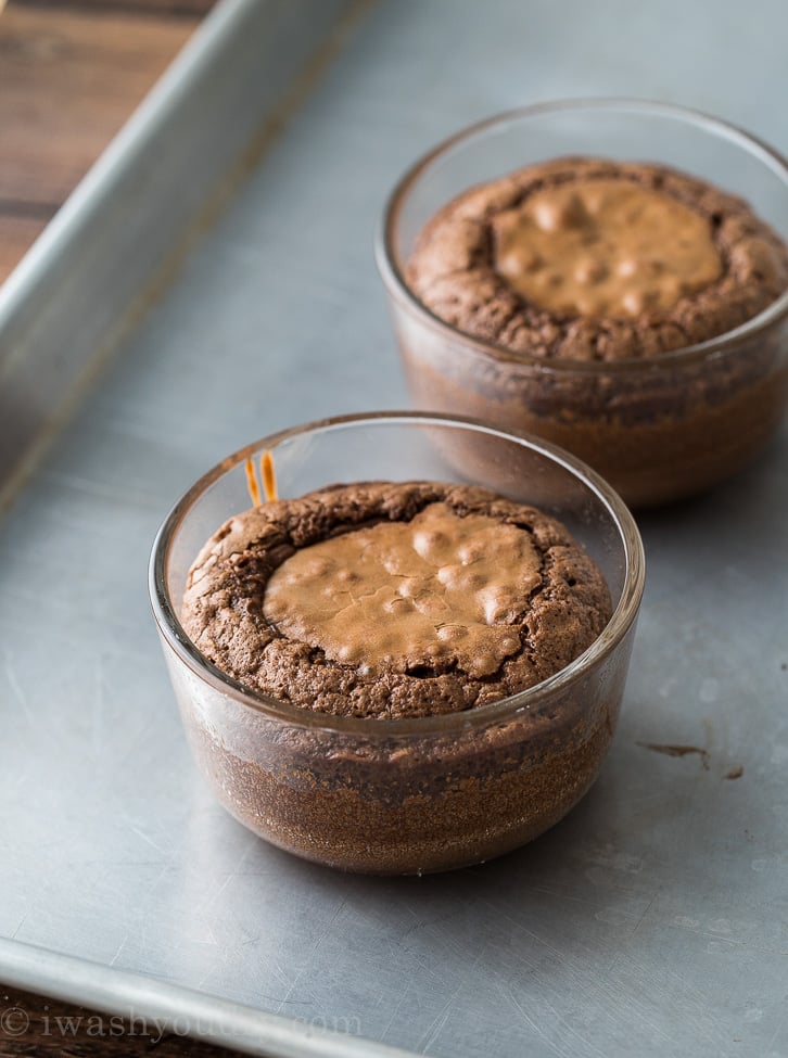 baked chocolate lava cake in glass dish on baking sheet.