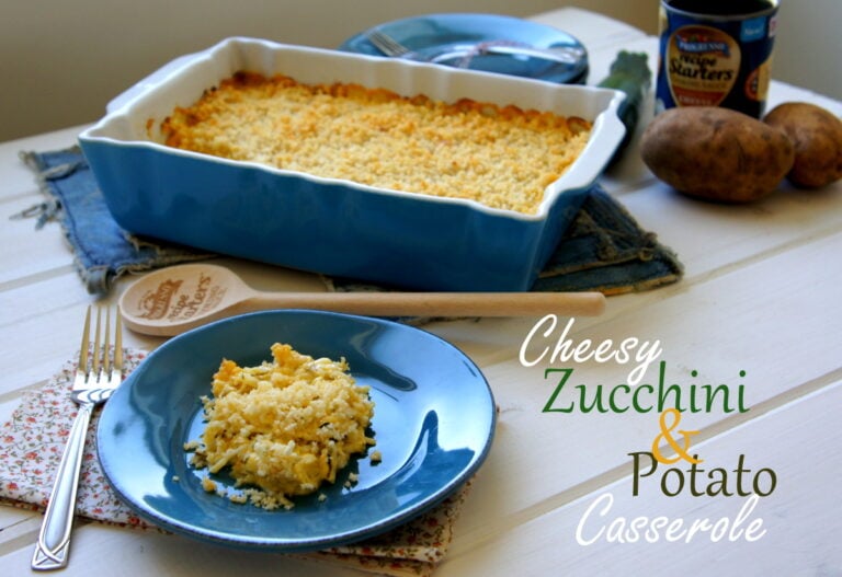 A scoop of casserole on a plate in front of a pan of Cheesy Zucchini and Potato Casserole
