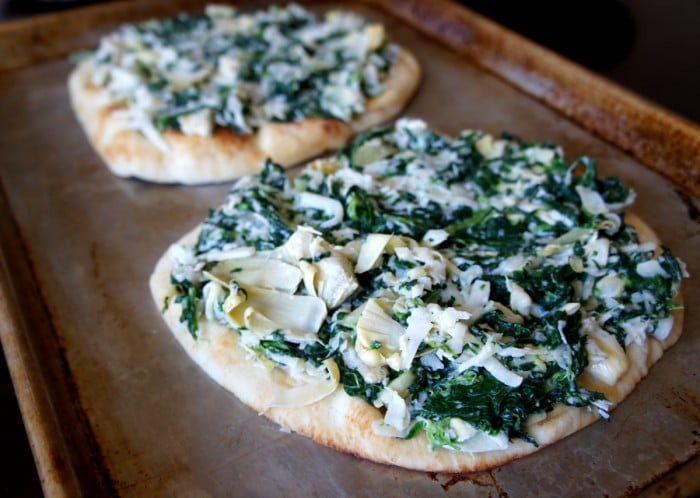Close up of two flat bread pizzas on a pan