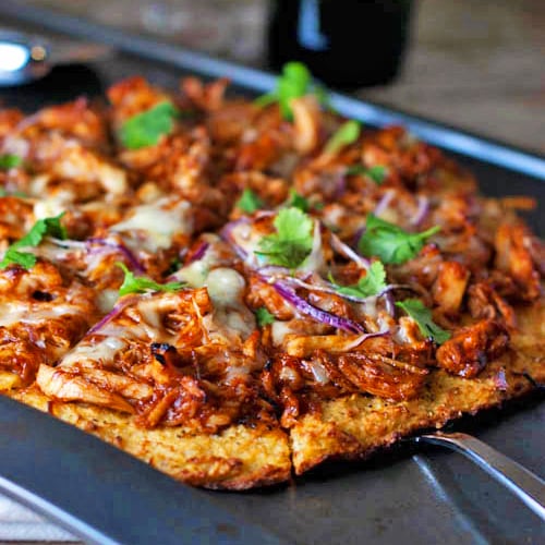 Close up of sliced BBQ chicken pizza on a pan