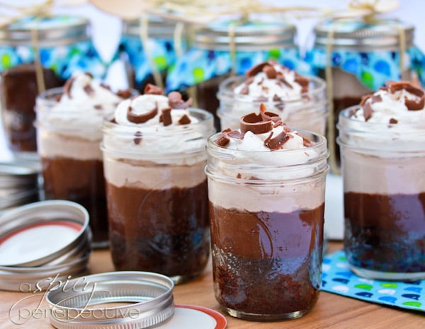 Chocolate Malt Brownie Parfaits in mason jars topped with whipped creamed chocolate shavings