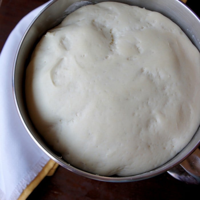A mixing bowl with raised dough in it