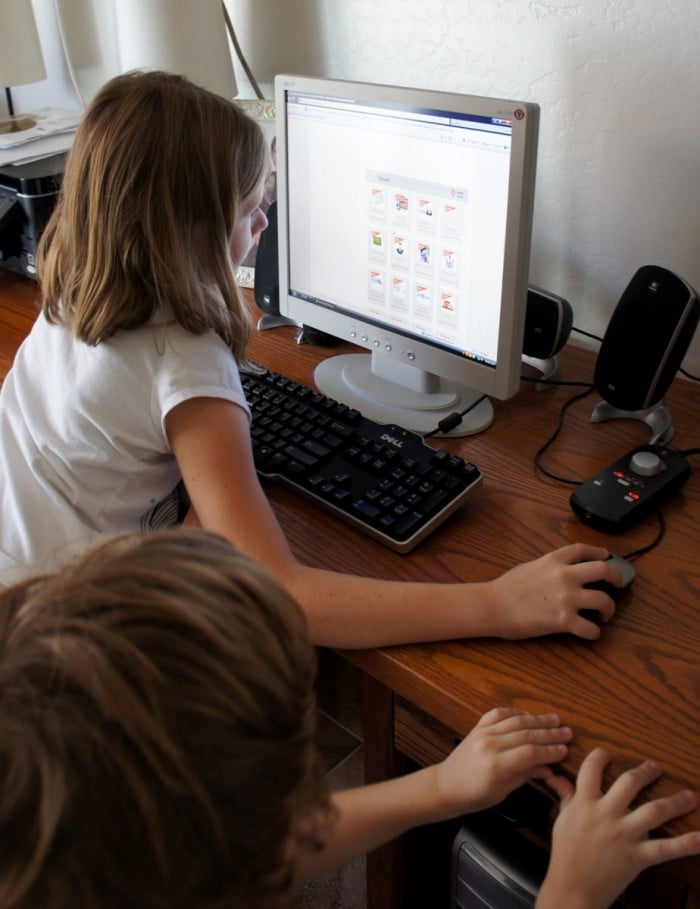 Children using the computer to check their jobs for the day
