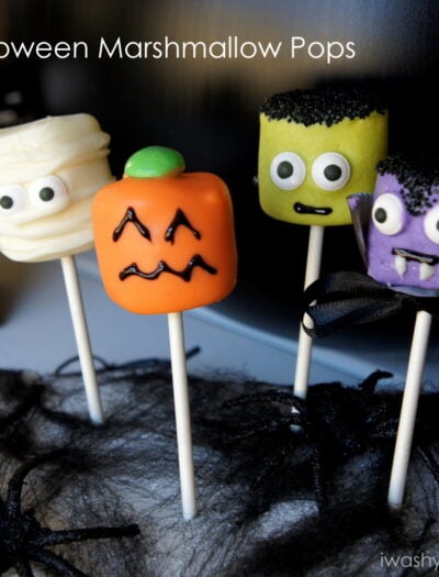 A display of Halloween themed marshmallow pops - mummy, pumpkin, Frankenstein and a vampire