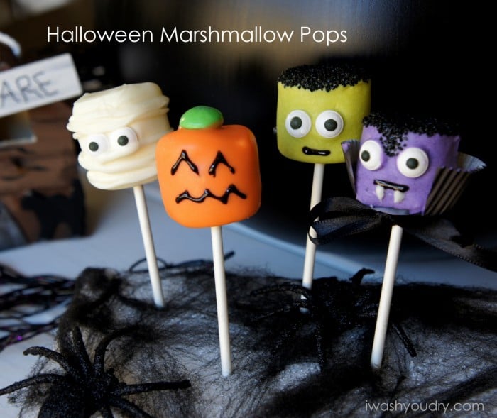 A display of Halloween themed marshmallow pops - mummy, pumpkin, Frankenstein and a vampire