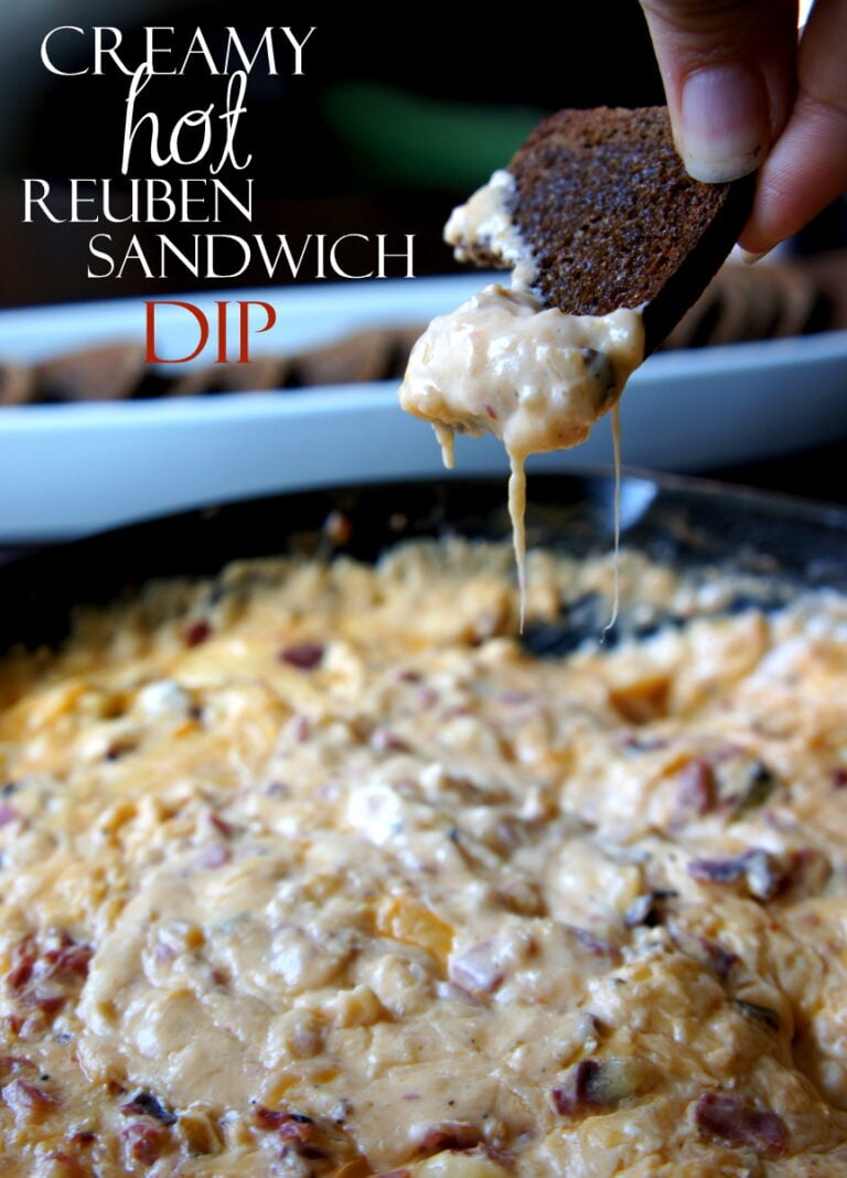 A hand dipping a chip into a dip titled, "Creamy Hot Reuben Sandwich Dip"