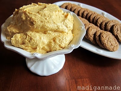 A serving bowl of Pumpkin Fluff next to a tray of gingersnaps