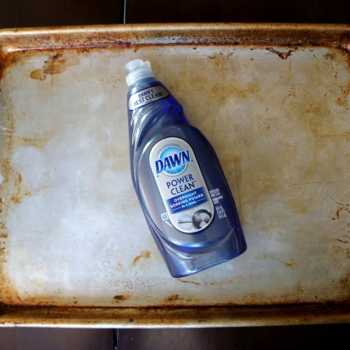 A bottle of Dawn Power clean soap on a dirty pan
