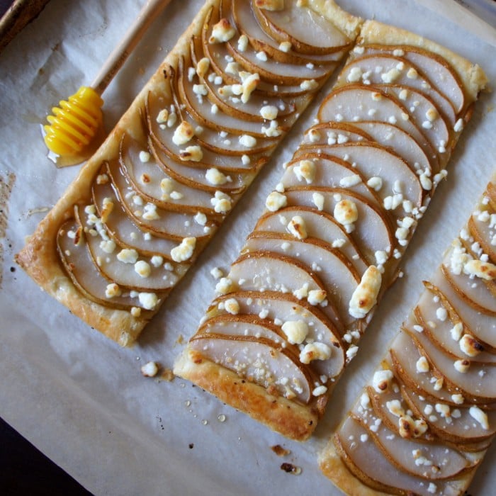 A Pear, Goat Cheese and honey Tart sliced in 3 sections