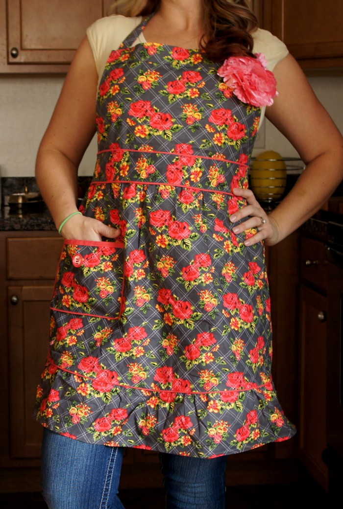 A close up of a woman wearing a flowered Jesse Steele apron