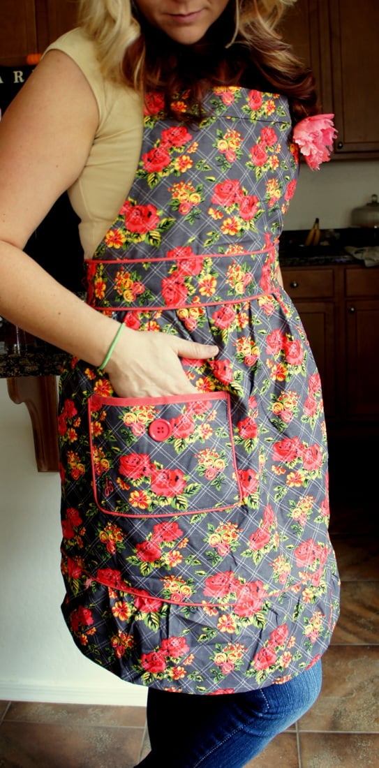 A close up of a woman with her hand in the pocket of a Jesse Steele Apron