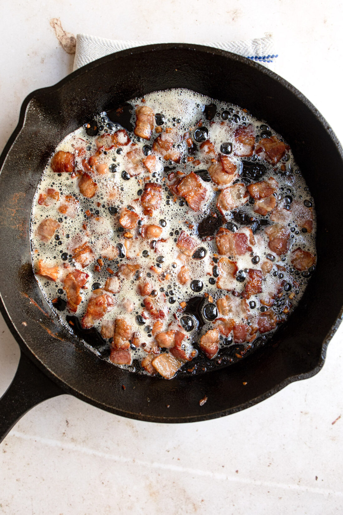 crispy bacon in hot skillet.