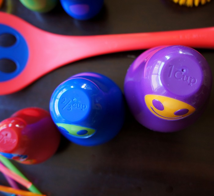 A close up of kid measuring cups