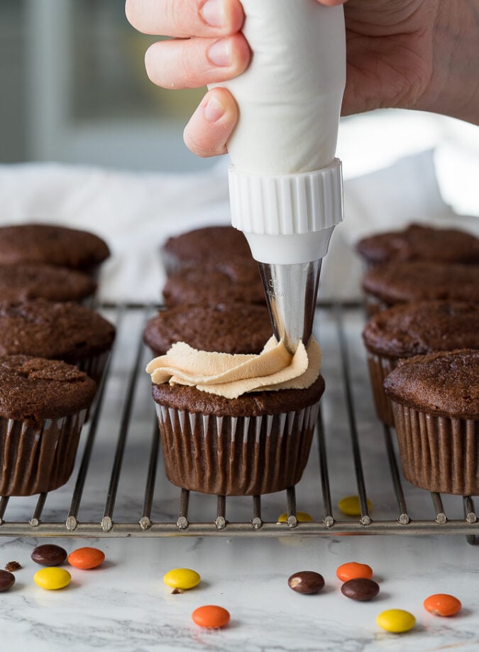 These Chocolate Cupcakes are so easy to make because they start with a classic box mix. Just a few tweaks and it's a bakery style cupcake worth Instagram!