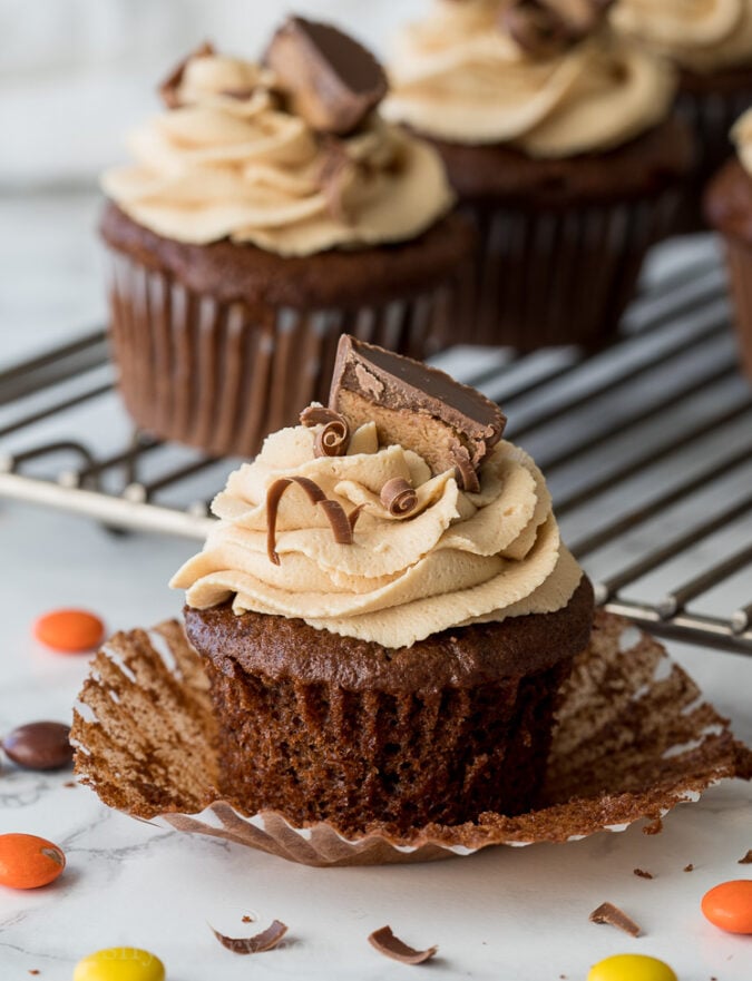 These Chocolate Peanut Butter Cupcakes with Peanut Butter Buttercream Frosting are filled with a surprise center that's sure to make you smile!