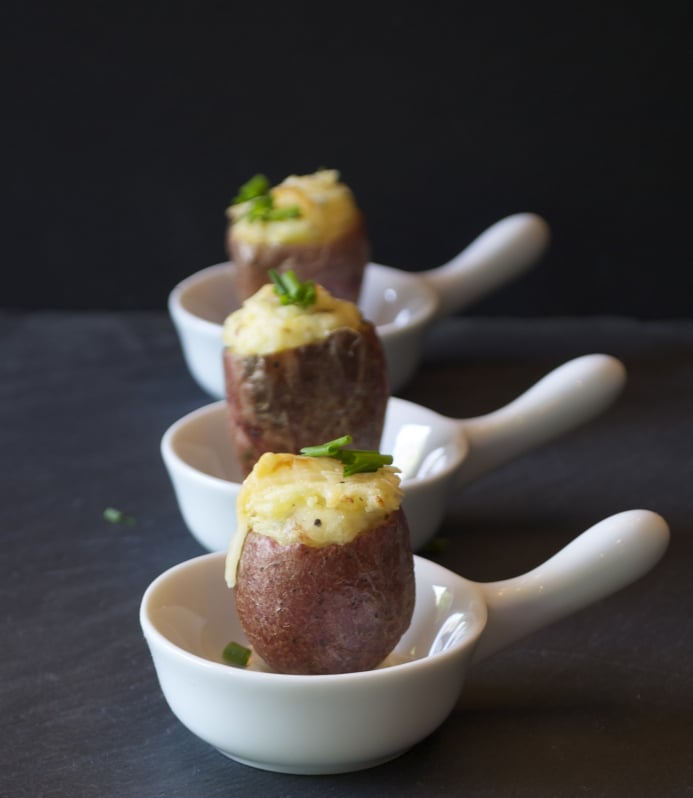 Three mini stuffed potatoes in 3 little bowls