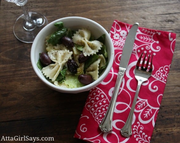 A bowl with artichokes and bowtie pasta