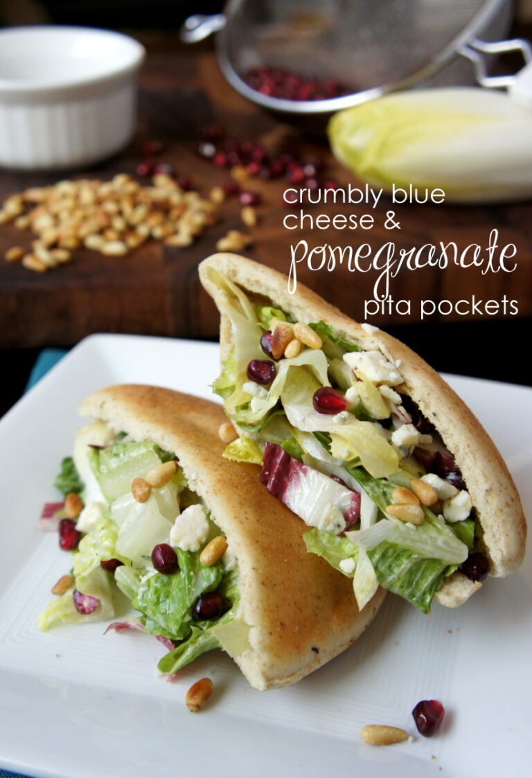 Two halves of a pita pocket sandwich on a plate