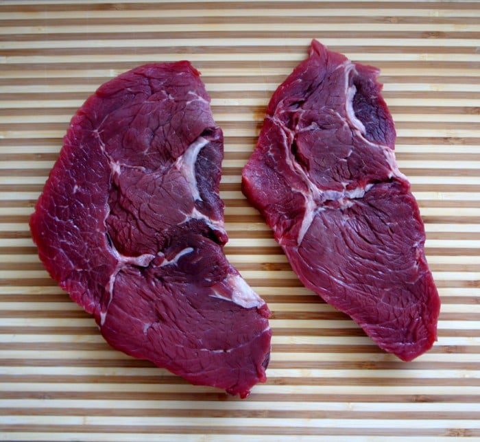 Two steaks on a table