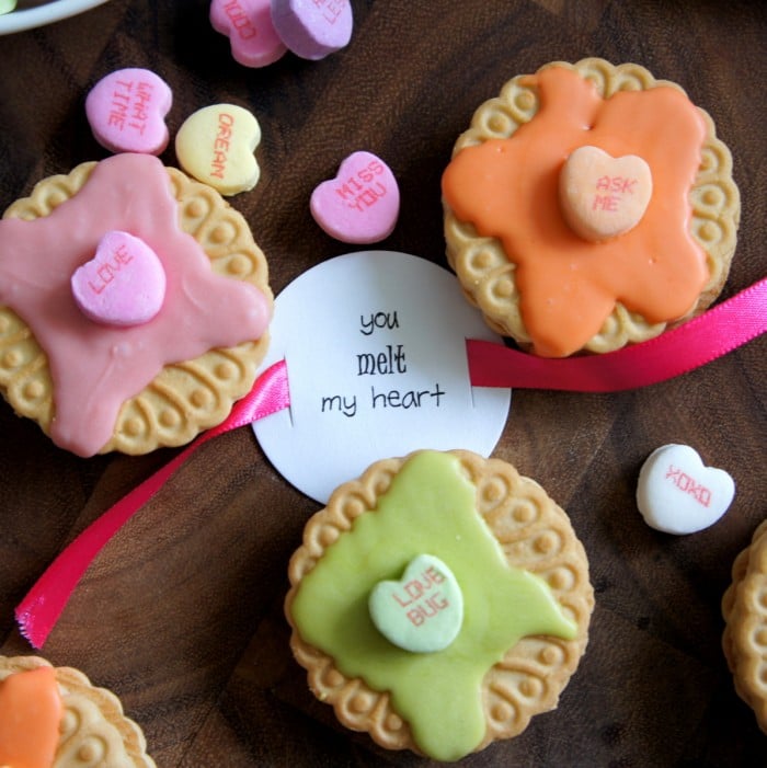 A close up of 3 Melt My Heart cookie Valentines