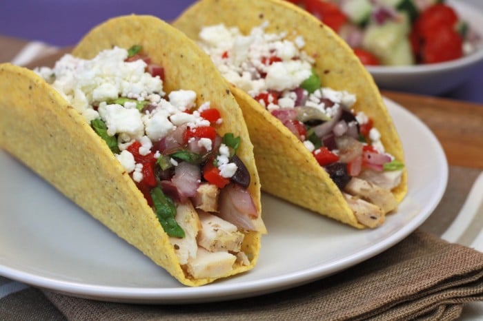 A close up of two tacos on a plate