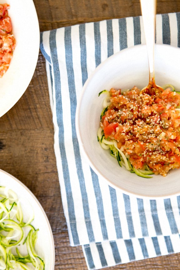 Zucchini pasta on a plate topped with a red sauce