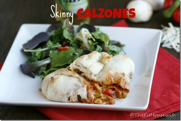A calzone on a plate with a side of salad