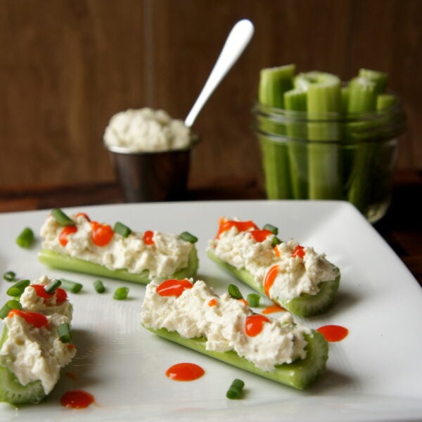 A plate with celery sticks filled with Creamy Buffalo Blue Cheese