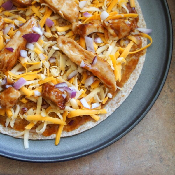 A close up of a plate with BBQ Chicken Tortilla Pizza